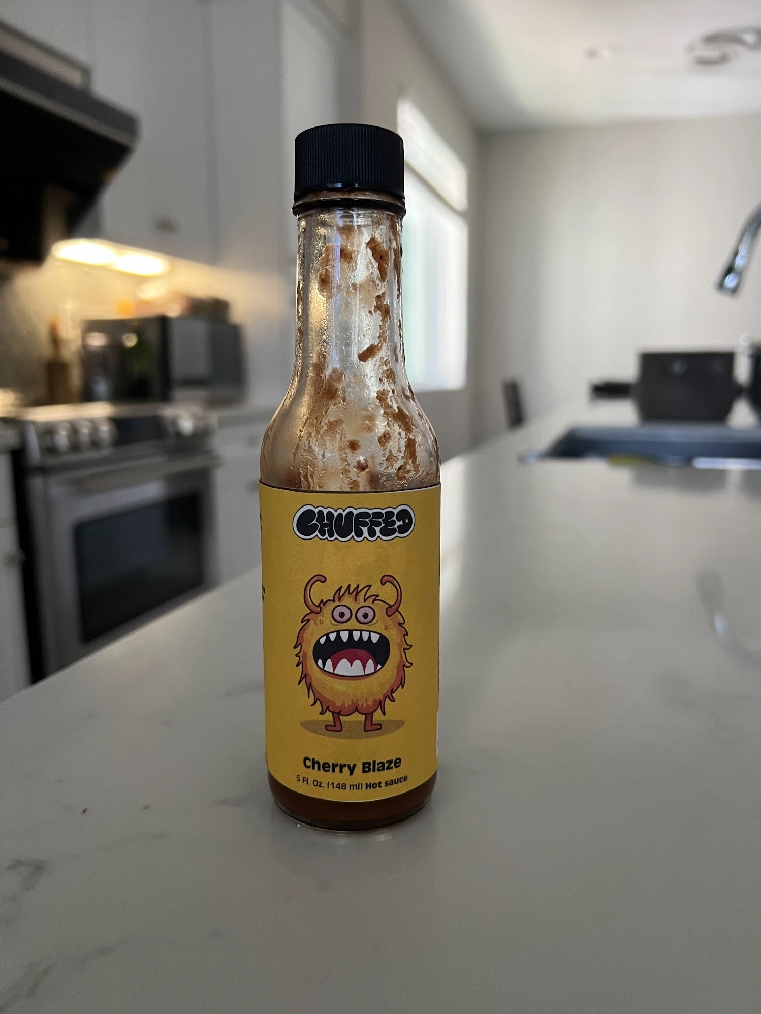 Cherry Blaze hot sauce sample on a kitchen counter